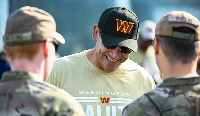 Washington Commanders head coach Ron Rivera chats with servicemembers from Joint Base Andrews during the fourth day of training camp at The Park, Ashburn, VA, July 30, 2022. (Photo by Brian Murphy)