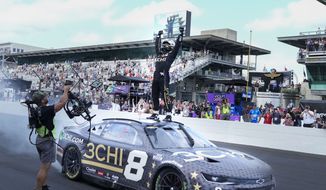 Tyler Reddick celebrates after winning a NASCAR Cup Series auto race at Indianapolis Motor Speedway, Sunday, July 31, 2022, in Indianapolis. (AP Photo/AJ Mast)