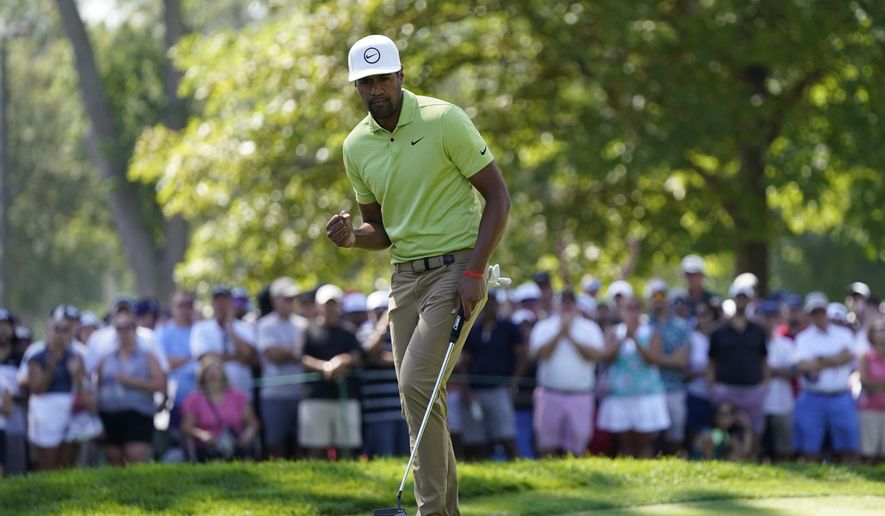 Tony Finau reacts after making his putt for par on the ninth green during the final round of the Rocket Mortgage Classic golf tournament, Sunday, July 31, 2022, in Detroit. (AP Photo/Carlos Osorio)