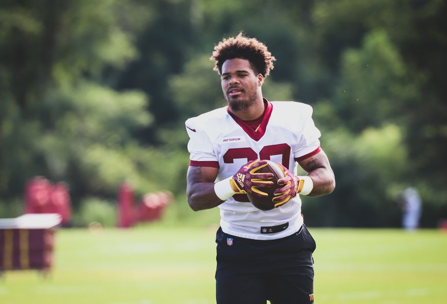 Washington Commanders Running Back Jaret Patterson (32) walking on the field, holding the football before practice at Day 5 of Training Camp at The Park in Ashburn VA on August 1st 2022. (Photo: Alyssa Howell)