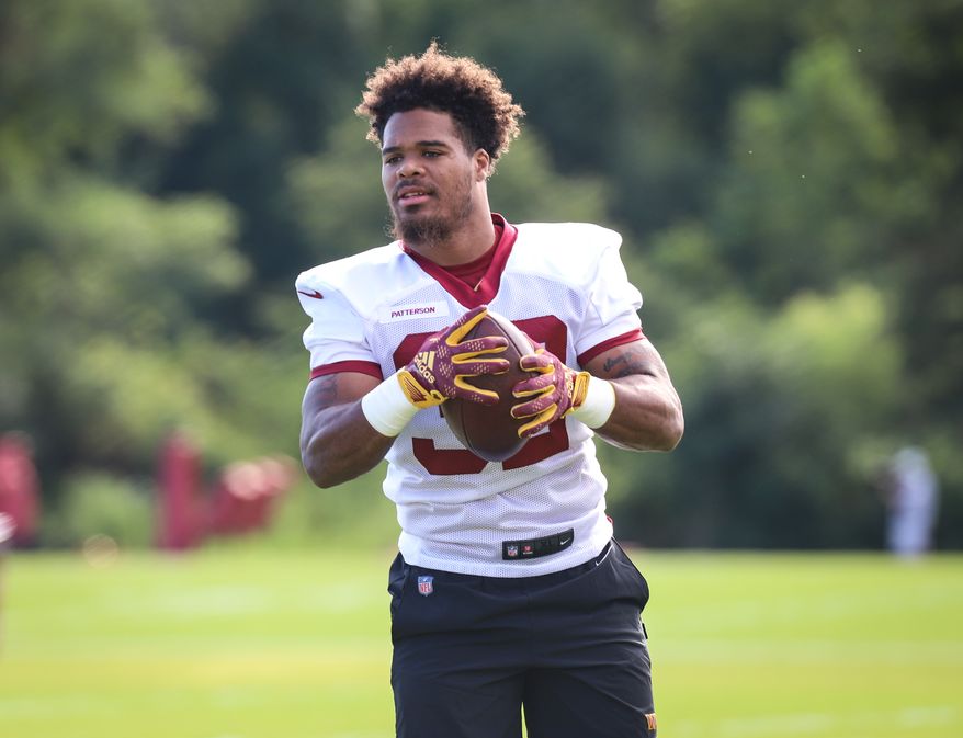 Washington Commanders Running Back Jaret Patterson (32) walking on the field, holding the football before practice at Day 5 of Training Camp at The Park in Ashburn VA on August 1st 2022. (Photo: Alyssa Howell)