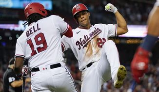 Washington Nationals&#39; Juan Soto, right, celebrates with Josh Bell after his solo home run during the fourth inning of a baseball game against the New York Mets at Nationals Park, Monday, Aug. 1, 2022, in Washington. (AP Photo/Alex Brandon)
