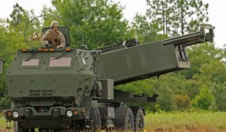 Marine Corps Sgt. Justin Russell, a High Mobility Artillery Rocket System, or HIMARS, section chief with Kilo Battery, 2nd Battalion, 14th Marines looks out over a firing range at Fort Stewart, Ga. during a training exercise, on June 13, 2015. Ukraine has received about a dozen American-built HIMARS multiple rocket launchers and has used them to strike Russian ammunition depots, which are essential for maintaining Moscow&#39;s edge in firepower. (Corey Dickstein/Savannah Morning News via AP, File)