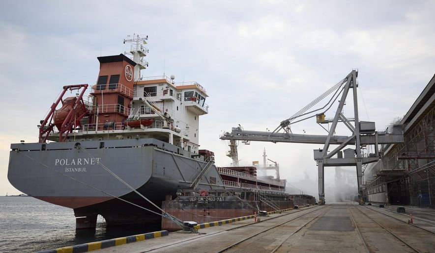 In this photo provided by the Ukrainian Presidential Press Office, a Turkish Polarnet cargo ship is loading Ukrainian grain in a port in Odesa region, Ukraine, Friday, July 29, 2022. (Ukrainian Presidential Press Office via AP)