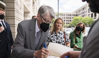 Author Stephen King signs books as he leaves federal court in Washington, after testifying for the Department of Justice as it bids to block the proposed merger of two of the world&#39;s biggest publishers, Penguin Random House and Simon &amp; Schuster, Tuesday, Aug. 2, 2022. (AP Photo/Manuel Balce Ceneta)