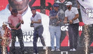 The &amp;quot;4 Aces&amp;quot; team celebrates with champagne after winning the team competition during a ceremony after the final round of the Bedminster Invitational LIV Golf tournament in Bedminster, N.J., Sunday, July 31, 2022. From left to right, Pat Perez, Talor Gooch, Patrick Reed and Dustin Johnson. (AP Photo/Seth Wenig)