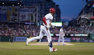 Washington Nationals&#39; Juan Soto, foreground, runs the bases after his solo home run off New York Mets starting pitcher Max Scherzer, back right, during the fourth inning of a baseball game at Nationals Park, Monday, Aug. 1, 2022, in Washington. (AP Photo/Alex Brandon) **FILE**