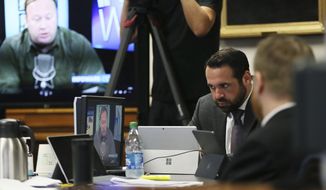 Bill Ogden, partner with the firm representing Neil Heslin and Scarlett Lewis, parents of parents of Sandy Hook shooting victim Jesse Lewis, reacts while watching a clip from InfoWars during the trial for Alex Jones on July 28, 2022. Although Jones portrays the lawsuit against him as an assault on the First Amendment, the parents who sued him say his statements were so malicious and obviously false that they fell well outside the bounds of speech protected by the constitutional clause. (Briana Sanchez/Austin American-Statesman via AP, Pool, File)