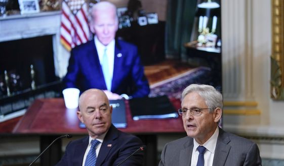 Attorney General Merrick Garland, right, speaks during the first meeting of the interagency Task Force on Reproductive Healthcare Access in the Indian Treaty Room in the Eisenhower Executive Office Building on the White House Campus in Washington, Wednesday, Aug. 3, 2022. Homeland Security Secretary Alejandro Mayorkas, left, and President Joe Biden, on screen, listen. (AP Photo/Susan Walsh) **FILE**