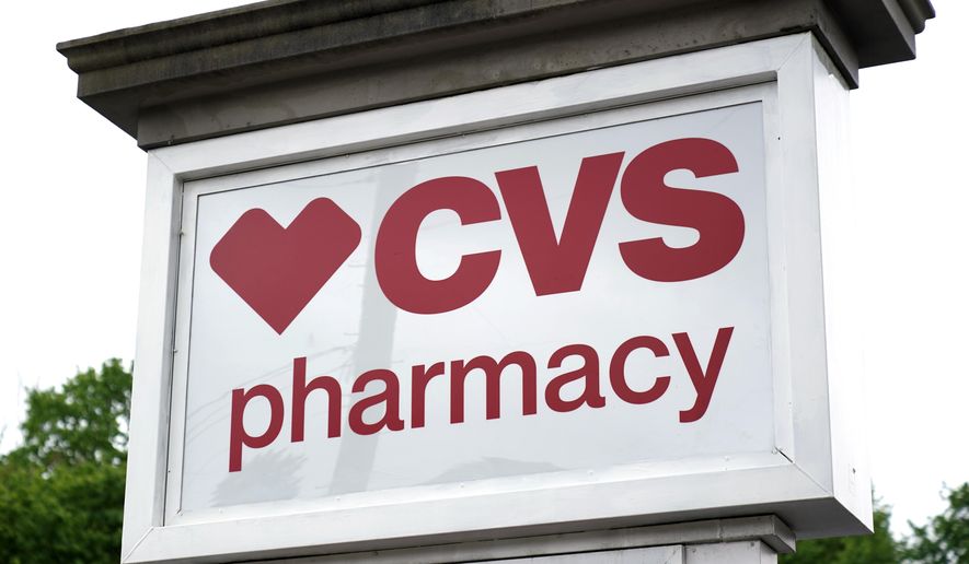 A CVS Pharmacy sign stands in Mount Lebanon, Pa., on Monday, May 3, 2021. (AP Photo/Gene J. Puskar, File)