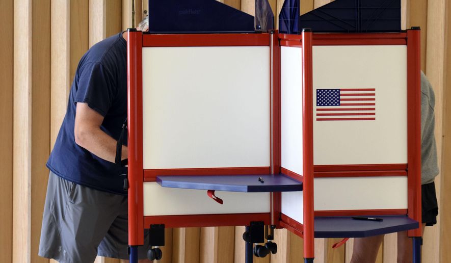 Residents fill out ballots while voting in a primary election Tuesday, Aug. 2, 2022, at the Zion St. Joe United Church of Christ in St. Joseph, Mich. (Don Campbell/The Herald-Palladium via AP)