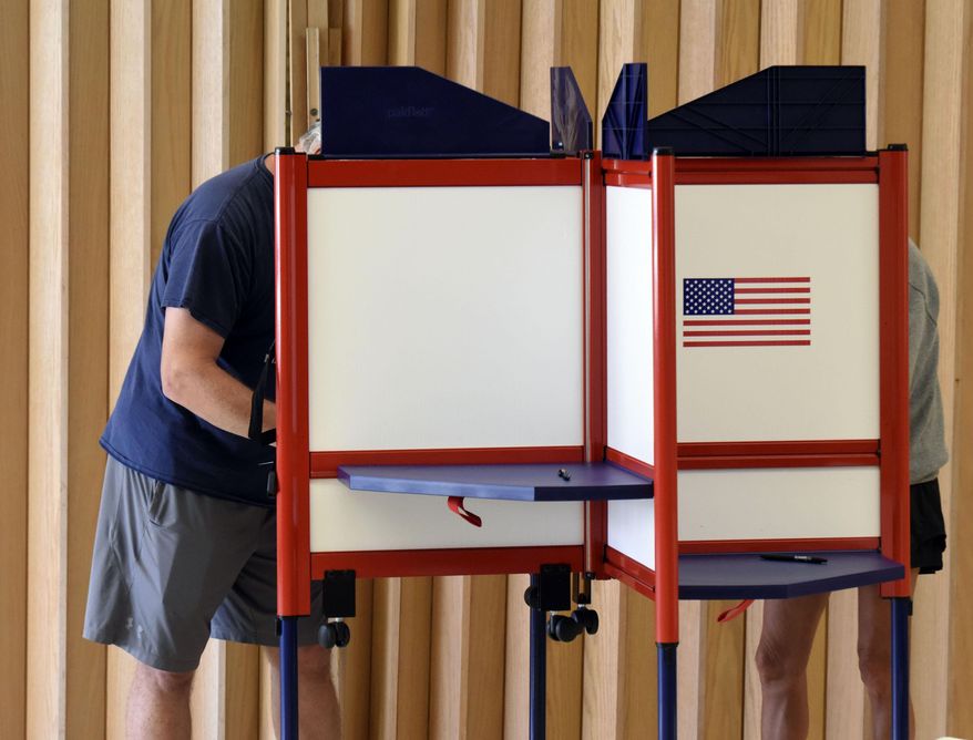 Residents fill out ballots while voting in a primary election Tuesday, Aug. 2, 2022, at the Zion St. Joe United Church of Christ in St. Joseph, Mich. (Don Campbell/The Herald-Palladium via AP)