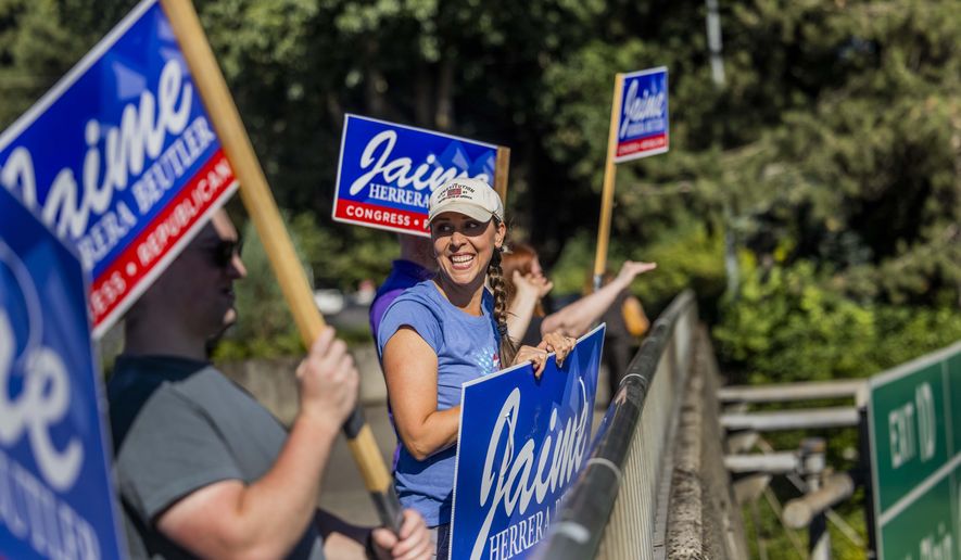 Republican Rep. Jaime Herrera Beutler does some last minute campaigning over Interstate 5 with supporters in Vancouver, Wash. Tuesday, Aug. 2, 2022. (Daniel Kim/The Seattle Times via AP)