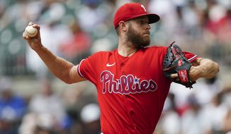Philadelphia Phillies starting pitcher Zack Wheeler delivers in the first inning of a baseball game against the Atlanta Braves Wednesday, Aug. 3, 2022, in Atlanta. (AP Photo/John Bazemore)