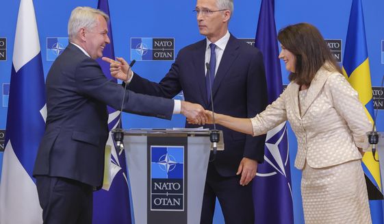 Finland&#39;s Foreign Minister Pekka Haavisto, left, Sweden&#39;s Foreign Minister Ann Linde, right, and NATO Secretary General Jens Stoltenberg attend a media conference after the signature of the NATO Accession Protocols for Finland and Sweden in the NATO headquarters in Brussels, July 5, 2022. (AP Photo/Olivier Matthys, File)
