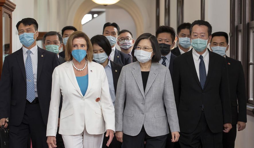 In this photo released by the Taiwan Presidential Office, U.S. House Speaker Nancy Pelosi, left, and Taiwanese President President Tsai Ing-wen arrive for a meeting in Taipei, Taiwan, Wednesday, Aug. 3, 2022. U.S. House Speaker Nancy Pelosi, meeting top officials in Taiwan despite warnings from China, said Wednesday that she and other congressional leaders in a visiting delegation are showing they will not abandon their commitment to the self-governing island. (Taiwan Presidential Office via AP)