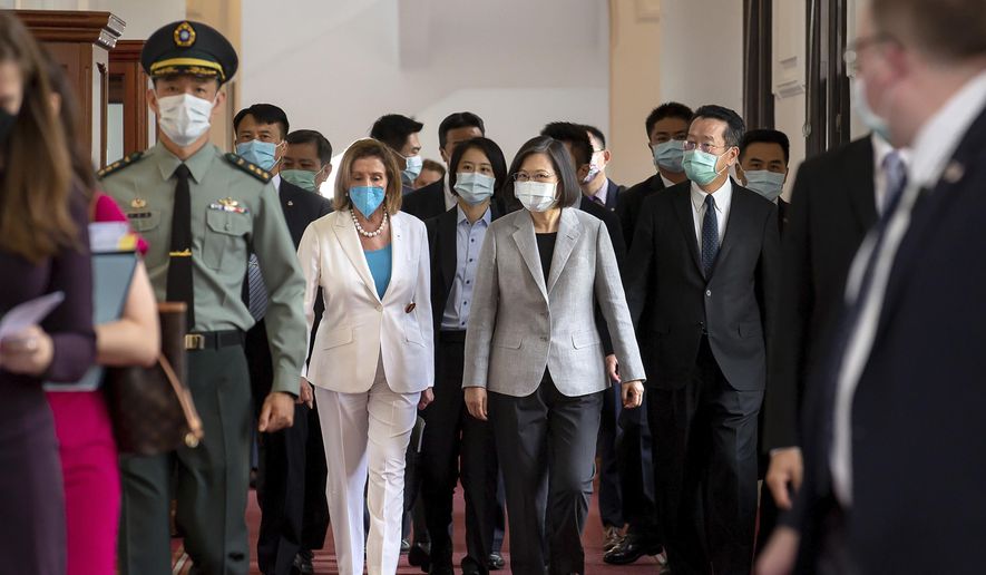 In this photo released by the Taiwan Presidential Office, U.S. House Speaker Nancy Pelosi, center left, and Taiwanese President Tsai Ing-wen arrive for a meeting in Taipei, Taiwan, Wednesday, Aug. 3, 2022. Pelosi, meeting top officials in Taiwan despite warnings from China, said Wednesday that she and other congressional leaders in a visiting delegation are showing they will not abandon their commitment to the self-governing island. (Taiwan Presidential Office via AP)