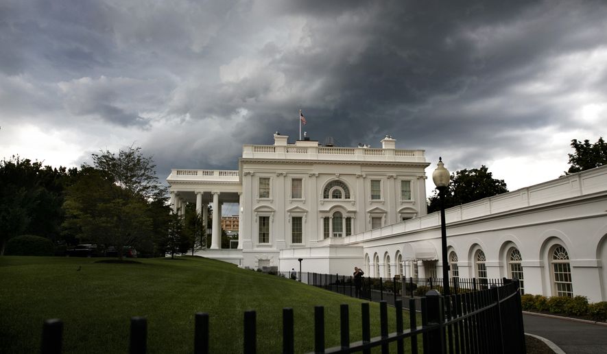 Storm clouds roll over the White House in this file photo from, Thursday June 20, 2019, in Washington. (AP Photo/Jacquelyn Martin)