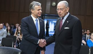 FBI Director Christopher A. Wray shakes hands with Senate Judiciary Committee ranking member Sen. Charles E. Grassley, R-Iowa, as he arrives to testify before the Senate Judiciary Committee on Capitol Hill in Washington, Thursday, Aug. 4, 2022. (AP Photo/Manuel Balce Ceneta) ** FILE **