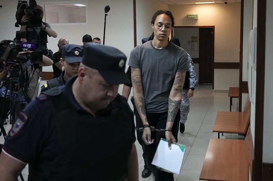 WNBA star and two-time Olympic gold medalist Brittney Griner is escorted in a court room prior to a hearing, in Khimki just outside Moscow, Russia, Thursday, Aug. 4, 2022. Closing arguments in Brittney Griner&#x27;s cannabis possession case are set for Thursday, nearly six months after the American basketball star was arrested at a Moscow airport in a case that reached the highest levels of US-Russia diplomacy. (AP Photo/Alexander Zemlianichenko)