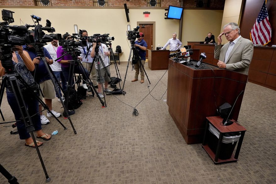 Pinal County Board of Supervisors Chairman Jeffrey McClure rubs his head while addressing ballot shortages in Pinal county, Wednesday, Aug. 3, 2022, in Florence, Ariz. (AP Photo/Matt York)