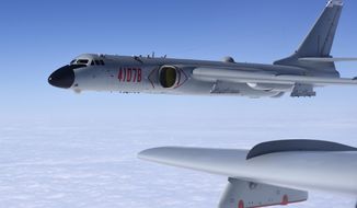 In this photo released by Xinhua News Agency, a Chinese military H-6K bomber is seen conducting training exercises, as the People&#39;s Liberation Army (PLA) air force conducted a combat air patrol in the South China Sea on Nov. 23, 2017. China is staging live-fire military drills in six self-declared zones surrounding Taiwan in response to a visit by U.S. House Speaker Nancy Pelosi to the island Beijing claims as its own territory. (Wang Guosong/Xinhua via AP, File)