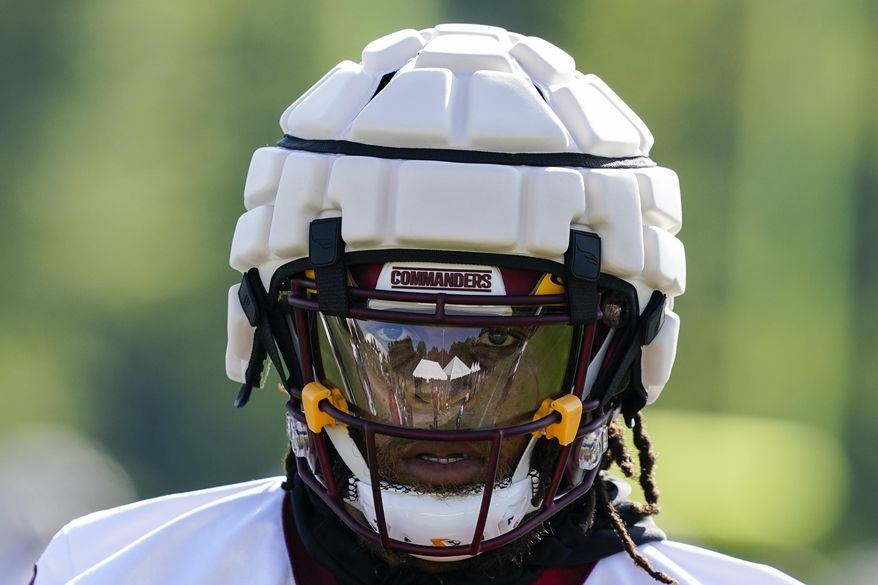 Washington Commanders running back Jonathan Williams wears a Guardian Cap football helmet during practice at the team's NFL football training facility, Wednesday, July 27, 2022 in Ashburn, Va. (AP Photo/Alex Brandon)