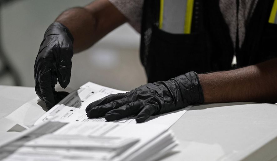 A worker prepares absentee ballots for mailing at the Wake County Board of Elections in Raleigh, N.C., Sept. 3, 2020. (AP Photo/Gerry Broome, File)