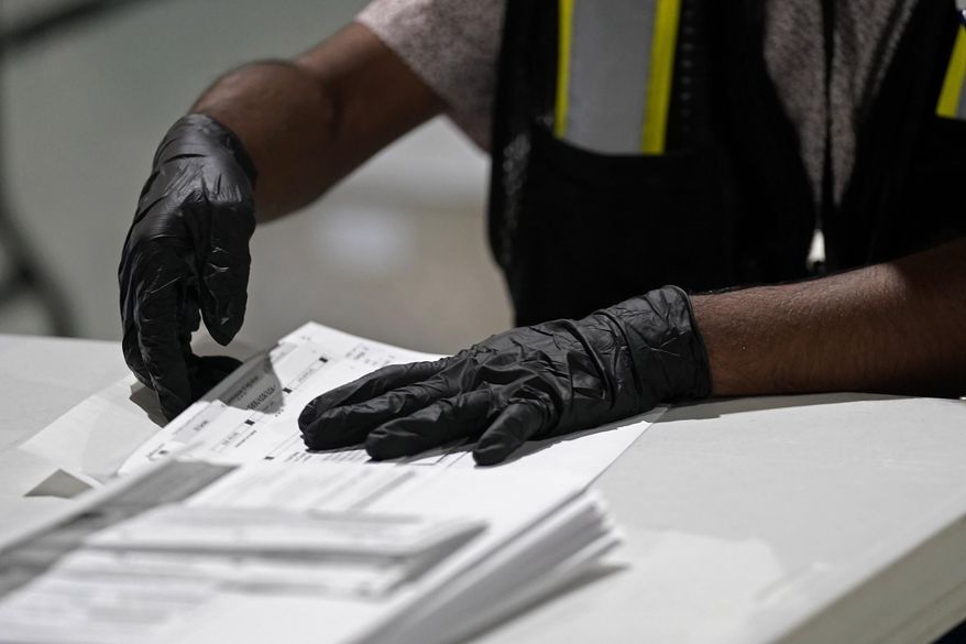 A worker prepares absentee ballots for mailing at the Wake County Board of Elections in Raleigh, N.C., Sept. 3, 2020. (AP Photo/Gerry Broome, File)