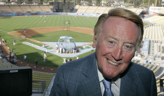 FILE -  Los Angeles Dodgers broadcaster Vin Scully poses in the pressbox of Dodger Stadium before the start of a baseball game between the San Francisco Giants and the Dodgers on Aug. 1, 2007, in Los Angeles. The Hall of Fame broadcaster, whose dulcet tones provided the soundtrack of summer while entertaining and informing Dodgers fans in Brooklyn and Los Angeles for 67 years, died Tuesday night, Aug. 2, 2022. He was 94. (AP Photo/Mark J. Terrill, File)