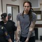 WNBA star and two-time Olympic gold medalist Brittney Griner is escorted from a court room ater a hearing, in Khimki just outside Moscow, Russia, Thursday, Aug. 4, 2022. A judge in Russia has convicted American basketball star Brittney Griner of drug possession and smuggling and sentenced her to nine years in prison. (AP Photo/Alexander Zemlianichenko)