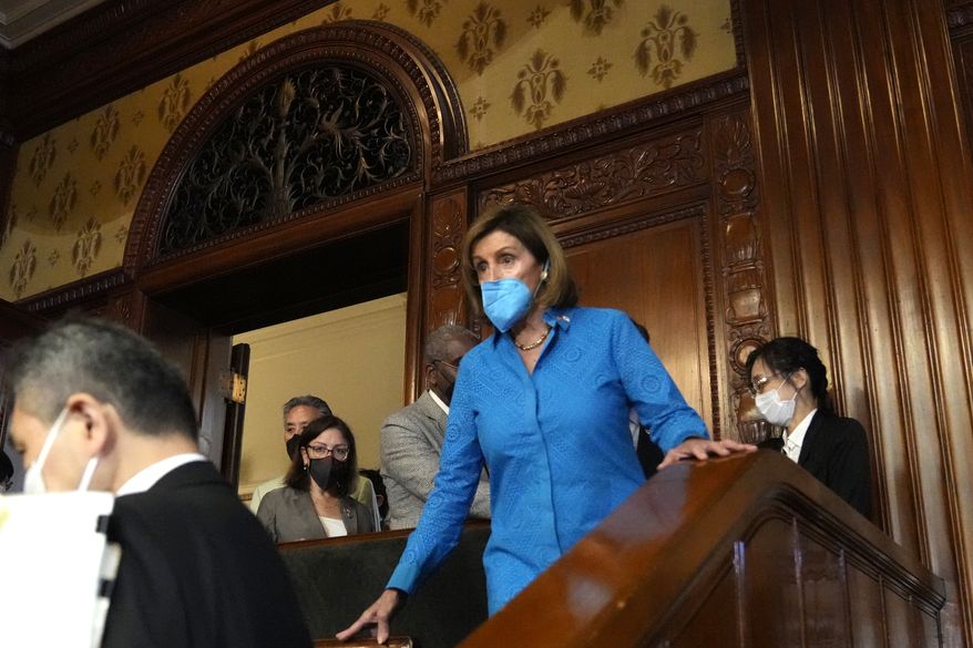 U.S. House Speaker Nancy Pelosi, center, visits the plenary session of the lower house in Tokyo, Friday, Aug. 5, 2022. Pelosi said Friday that China will not isolate Taiwan by preventing U.S. officials from traveling there. (AP Photo/Shuji Kajiyama)
