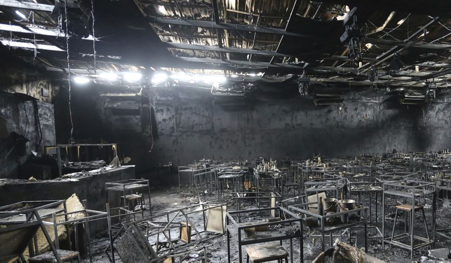 Major fire damage fills the interior at the Mountain B pub in the Sattahip district of Chonburi province, about 160 kilometers (100 miles) southeast of Bangkok, Thailand. More than a dozen people were killed and dozens injured when a fire broke out early Friday morning at the crowded music pub, police and rescue workers said. (AP Photo/Anuthep Cheysakron)