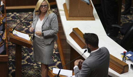 Republican Rep. Wendy McNamara, left, listens to questions from Republican Rep. Matt Hostettler, right, before a vote is held on Senate Bill 1 during a special session Friday, Aug. 5, 2022, at the Indiana Statehouse in Indianapolis. The bill bans abortions at zero weeks except in the cases of rape, incest or to protect the life of the pregnant person. (Jenna Watson/The Indianapolis Star via AP)