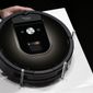 A Roomba 980 vacuum cleaning robot is presented during a presentation  in Tokyo, Tuesday, Sept. 29, 2015. Amazon on Friday, Aug. 5, 2022, announced it has entered into an agreement to acquire the vacuum cleaner maker iRobot for approximately $1.66 billion. The company sells its robots worldwide and is most famous for the circular-shaped Roomba vacuum.  (AP Photo/Eugene Hoshiko)