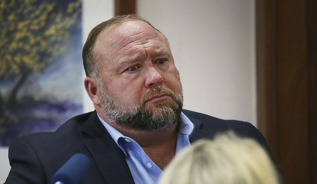 Conspiracy theorist Alex Jones attempts to answer questions about his emails asked by Mark Bankston, lawyer for Neil Heslin and Scarlett Lewis, during a trial at the Travis County Courthouse in Austin, Wednesday, Aug. 3, 2022. (Briana Sanchez/Austin American-Statesman via AP, Pool) ** FILE **