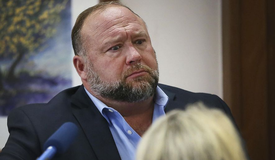 Conspiracy theorist Alex Jones attempts to answer questions about his emails asked by Mark Bankston, lawyer for Neil Heslin and Scarlett Lewis, during trial at the Travis County Courthouse in Austin, Wednesday Aug. 3, 2022. Jones testified Wednesday that he now understands it was irresponsible of him to declare the Sandy Hook Elementary School massacre a hoax and that he now believes it was “100% real.&amp;quot; (Briana Sanchez/Austin American-Statesman via AP, Pool)