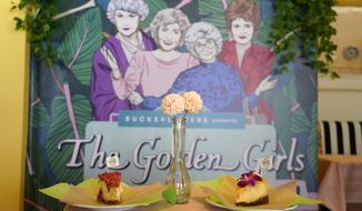 Cheesecake dessert items are pictured in front of a portrait of &amp;quot;The Golden Girls&amp;quot; cast at the Golden Girls Kitchen pop-up restaurant, Monday, July 25, 2022, in Beverly Hills, Calif. The pop-up only has reservations through the end of October. But there are plans to take it on the road to New York, Chicago, San Francisco and Miami. (AP Photo/Chris Pizzello)