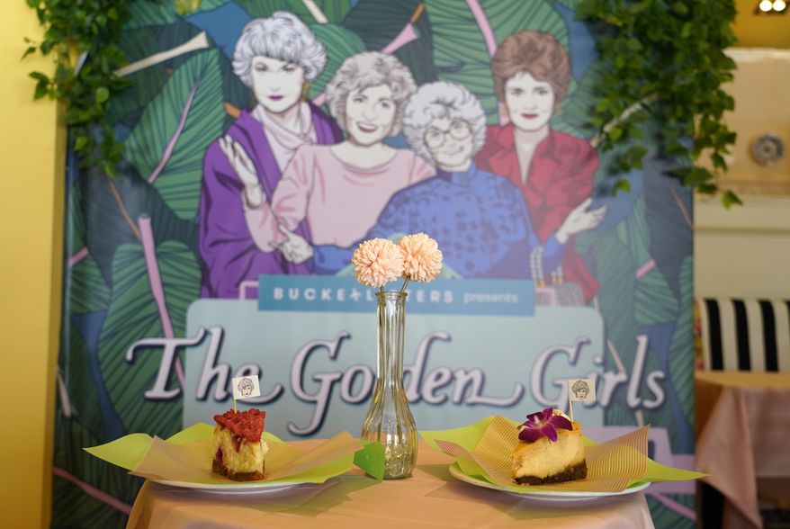 Cheesecake dessert items are pictured in front of a portrait of &amp;quot;The Golden Girls&amp;quot; cast at the Golden Girls Kitchen pop-up restaurant, Monday, July 25, 2022, in Beverly Hills, Calif. The pop-up only has reservations through the end of October. But there are plans to take it on the road to New York, Chicago, San Francisco and Miami. (AP Photo/Chris Pizzello)