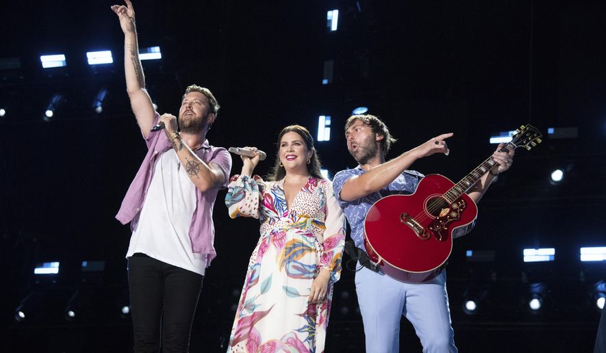Charles Kelley, from left, Hillary Scott, and Dave Haywood of Lady A perform during CMA Fest 2022 in Nashville, Tenn., on June 12, 2022. Grammy-winning country trio Lady A are postponing their tour this year to as band member Charles Kelley focuses on sobriety. The band was due to start their tour in August in Nashville. (Photo by Amy Harris/Invision/AP, File)