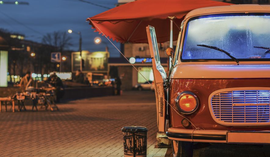 Food Truck on wheels in night street. File photo credit alexfan32 via Shutterstock.