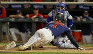 Toronto Blue Jays catcher Danny Jansen drops the ball, allowing Minnesota Twins&#39; Nick Gordon to score the winning run during the 10th inning of a baseball game Friday, Aug. 5, 2022, in Minneapolis. The Twins won 6-5. (AP Photo/Bruce Kluckhohn)