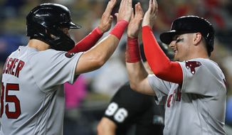 Boston Red Sox&#39;s Eric Hosmer, left, and Reese McGuire, celebrate after scoring against the Kansas City Royals on a double by Jarren Duran during the eighth inning of a baseball game Friday, Aug. 5, 2022, in Kansas City, Mo. (AP Photo/Reed Hoffmann)