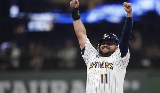 Milwaukee Brewers&#39; Rowdy Tellez gestures to the dugout after stealing second base during the third inning of the team&#39;s baseball game against the Cincinnati Reds on Friday, Aug. 5, 2022, in Milwaukee. (AP Photo/Aaron Gash)