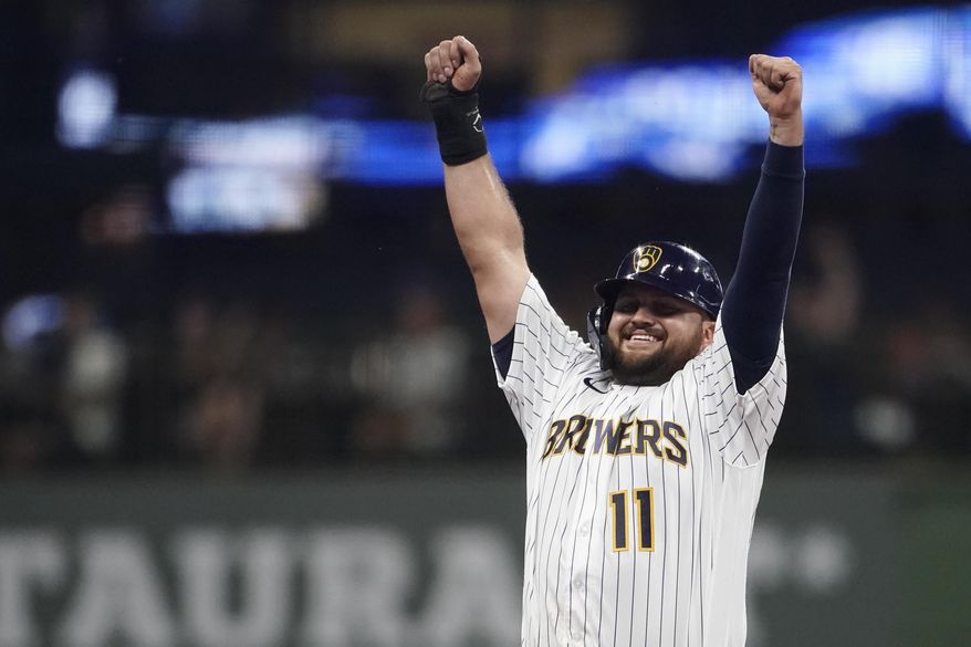 Milwaukee Brewers&#39; Rowdy Tellez gestures to the dugout after stealing second base during the third inning of the team&#39;s baseball game against the Cincinnati Reds on Friday, Aug. 5, 2022, in Milwaukee. (AP Photo/Aaron Gash)