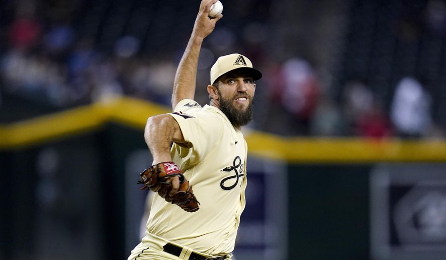 Arizona Diamondbacks starting pitcher Madison Bumgarner throws against the Colorado Rockies during the first inning of a baseball game Friday, Aug. 5, 2022, in Phoenix. (AP Photo/Ross D. Franklin)