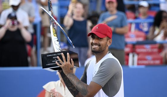 Nick Kyrgios, of Australia, poses with the trophy after he defeated Yoshihito Nishioka, of Japan, during a final at the Citi Open tennis tournament Sunday, Aug. 7, 2022, in Washington. Kyrgios won 6-4, 6-3. (AP Photo/Nick Wass)