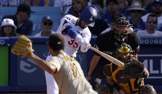 Los Angeles Dodgers&#39; Cody Bellinger, second from left, hits a solo home run as San Diego Padres starting pitcher Yu Darvish, left, watches along with catcher Austin Nola, right, and home plate umpire Lance Barksdale during the third inning of a baseball game Sunday, Aug. 7, 2022, in Los Angeles. (AP Photo/Mark J. Terrill)