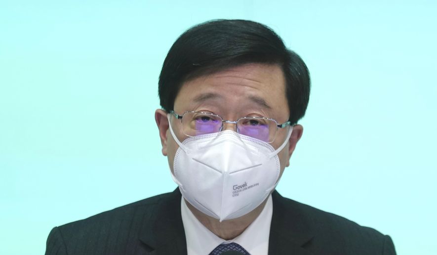 Hong Kong Chief Executive John Lee speaks during a news conference in Hong Kong, Monday, Aug. 8, 2022. Lee said Monday that the length of mandatory hotel quarantine for overseas arrivals will be reduced to three days from a week. (AP Photo/Kin Cheung)