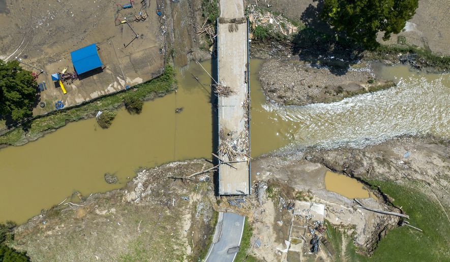 A bridge along KY-3351 over Troublesome Creek near Ary in Perry County, Ky., remains damaged Tuesday, Aug. 2, 2022, following flooding the week before that devastated many counties in Eastern Kentucky. (Ryan C. Hermens/Lexington Herald-Leader via AP, File)